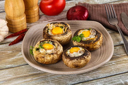 Baked champignon with quail egg and parsleyの写真素材