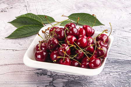 Red sweet juicy cherry in the bowl