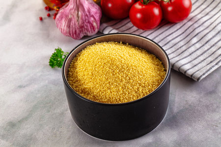 Vegan cuisine - raw dry couscous in the bowlの写真素材