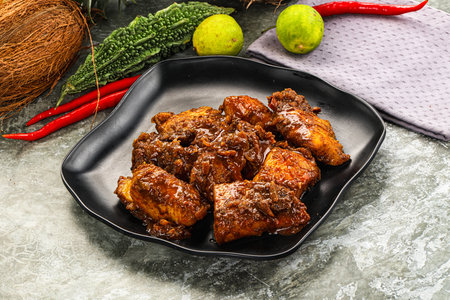 Indian cuisine - Vindaloo fish with spices and garnishの写真素材