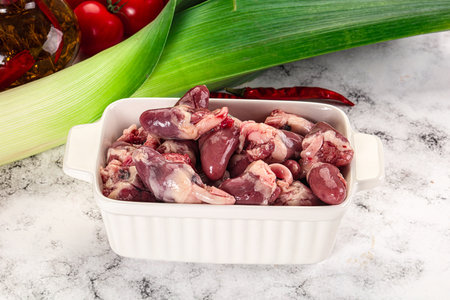 Raw chicken hearts in the bowl for cookingの写真素材