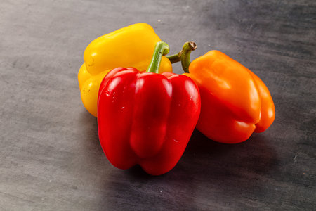Red, yellow, orange bell pepper heapの写真素材
