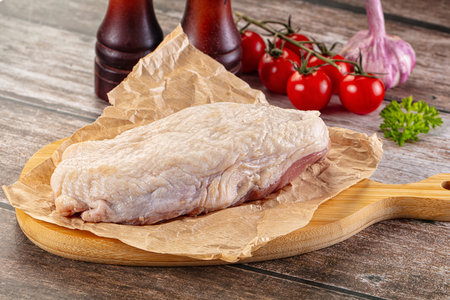 Raw duck breast fillet for cooking ovet boardの写真素材
