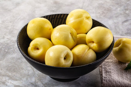 Yellow nectarines heap in the bowlの写真素材