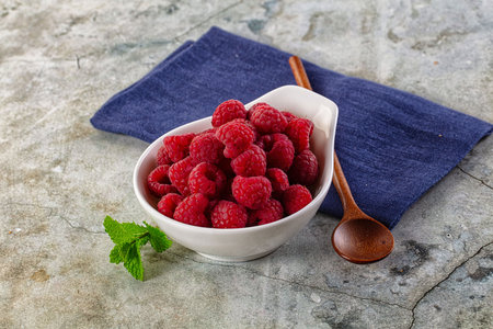 Organic ripe sweet juicy raspberry in the bowl
