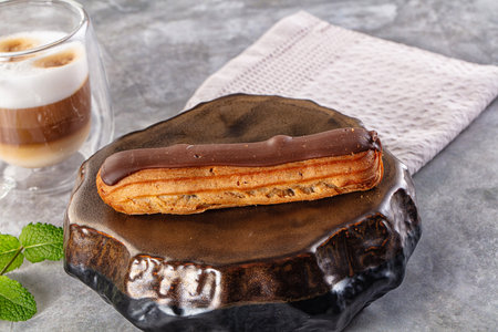 Gourmet chocolate eclair with brown icing