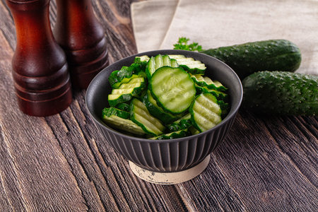Fresh green ripe cucumber slices in the bowlの写真素材