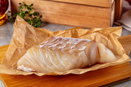 Raw code fish fillet for cooking over board