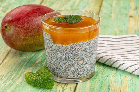 Sweet dessert witn mango and chia served mint leavesの写真素材