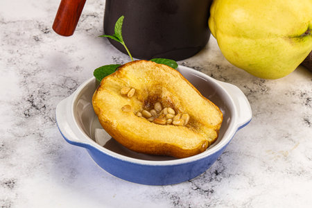 Baked quince with honey and cedar nutsの写真素材