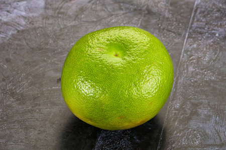 Green ripe fruit sweetie citrus over background