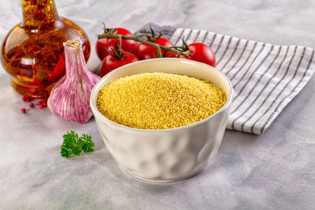 Vegan cuisine - raw dry couscous in the bowl