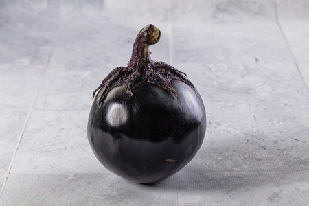 Raw roundripe black big eggplantの写真素材