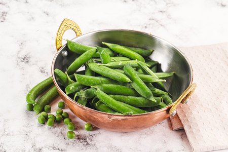 Sweet young green peas heap in the bowlの写真素材