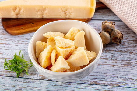 Hard Italian Parmesan cheese pieces in the bowlの写真素材