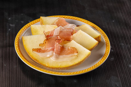 Slised sweet melon with Jamon serranoの写真素材