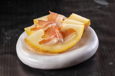 Slised sweet melon with Jamon serranoの写真素材