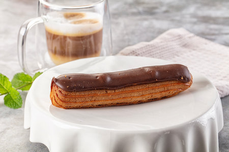 Gourmet chocolate eclair with brown icing