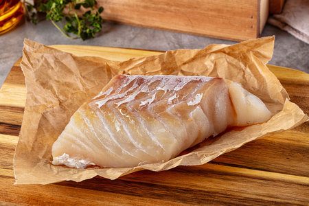 Raw code fish fillet for cooking over board