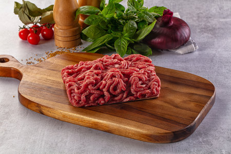 Raw minced beef meat over board for cooking