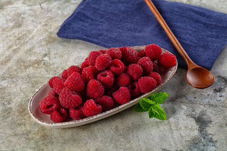 Ripe sweet juicy raspberry in the bowl