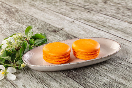 Sweet almond cookies orange macaroons served flowerの写真素材
