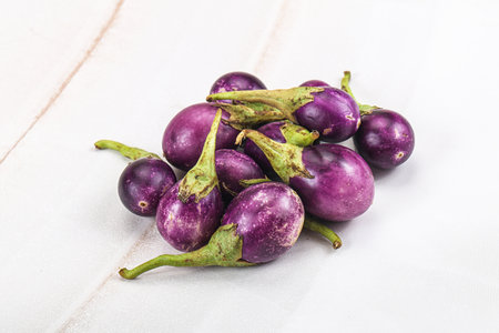Small organic young purple round eggplant heap