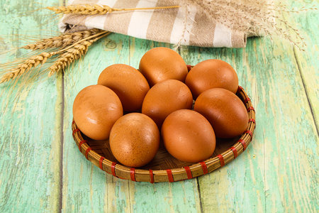 Raw brown chicken egg heap in the bowl