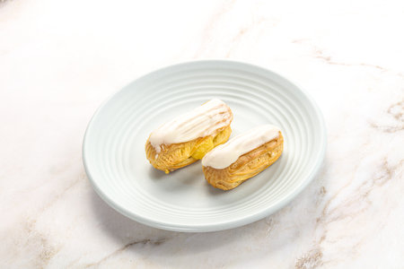 Delicious tasty eclair with icing and cream