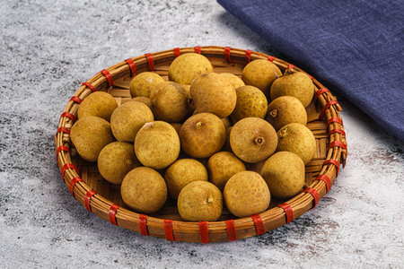 Sweet juicy tropical fruit longan in the bowl