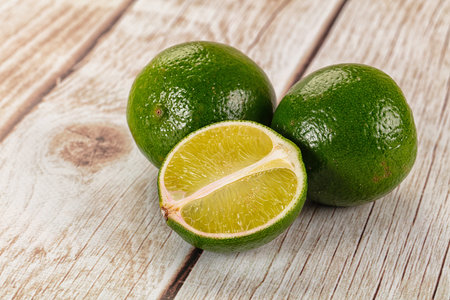 Ripe green juicy lime heap with half slice