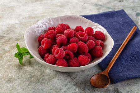 Organic ripe sweet juicy raspberry in the bowl