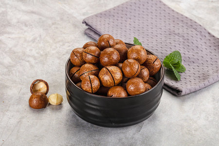 Sweet macadamia nut heap in the bowlの写真素材