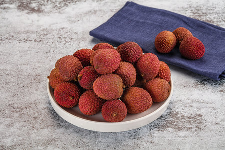 Sweet juicy tropical fruit lychee heap in the bowlの写真素材