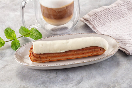 White delicous vanilla eclair with icing dessert