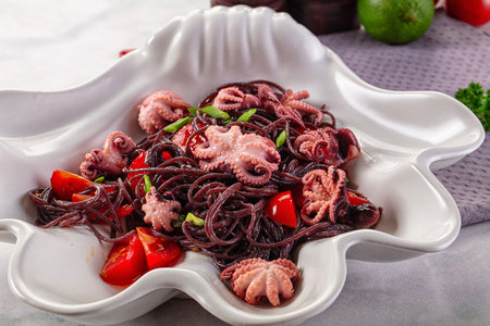 Gourmet black spaghetti with octopus and tomatoの写真素材