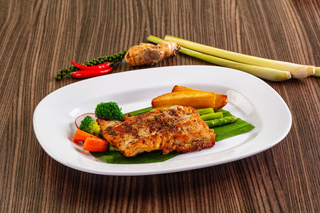 Gourmet asian Grilled crocodile steak served potato and asparagus