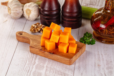 Yellow cheddar cheese cubes snack in the bowlの写真素材