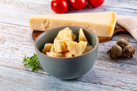 Hard Italian Parmesan cheese pieces in the bowlの写真素材