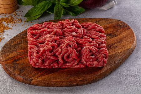 Raw minced beef meat over board for cooking