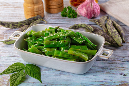 Steamed green bean strings heap with olive oilの写真素材