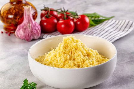 Boiled wheat couscous grain garnish in the bowlの写真素材