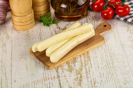White mozzarella sticks over board snack