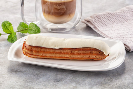 White delicous vanilla eclair with icing dessert