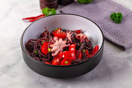 Gourmet black spaghetti with octopus and tomatoの写真素材