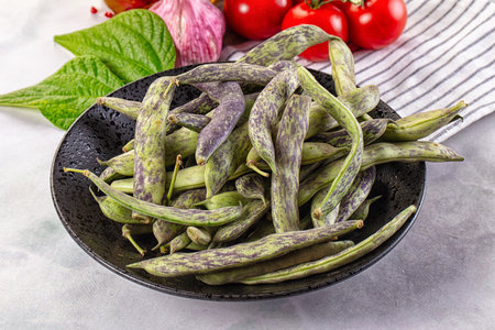 Raw green bean strips heap in the bowl