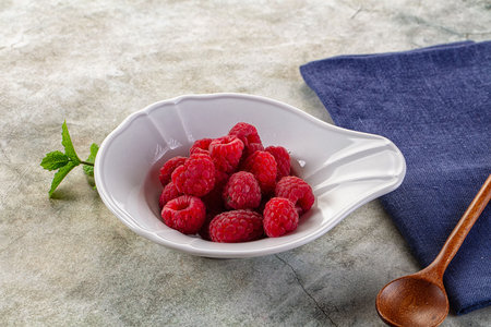Organic ripe sweet juicy raspberry in the bowlの写真素材