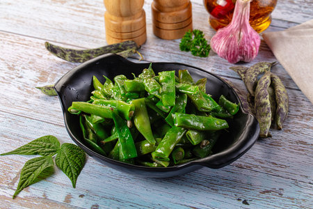Steamed green bean strings heap with olive oil