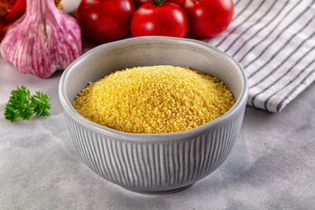 Vegan cuisine - raw dry couscous in the bowlの写真素材