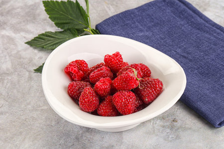 Ripe sweet and juicy organic raspberry in the bowl